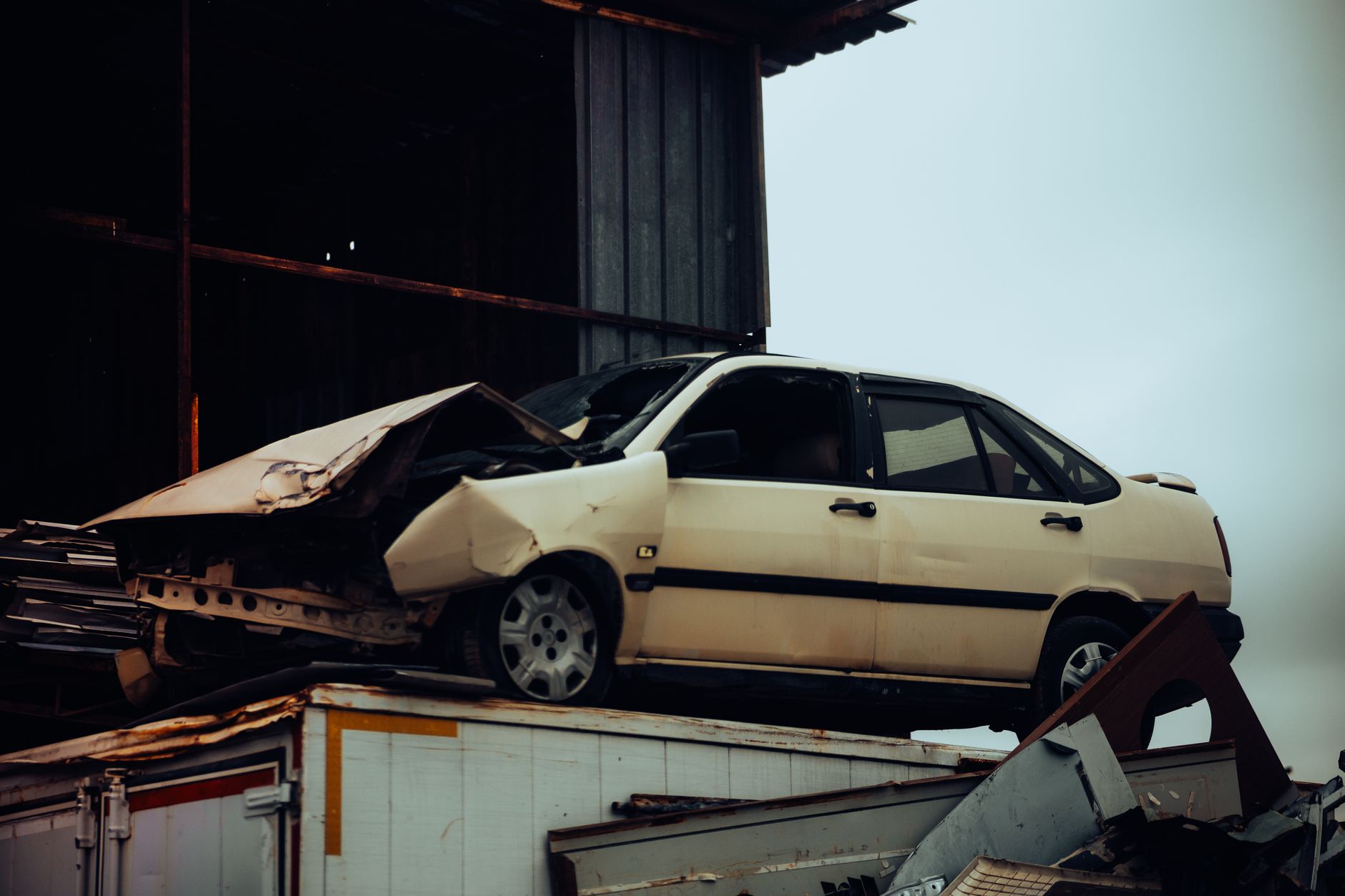 A damaged car sits atop a metal scrap heap, the kind of bulky job a junk removal in my area search should turn up a local Port St Lucie crew for.